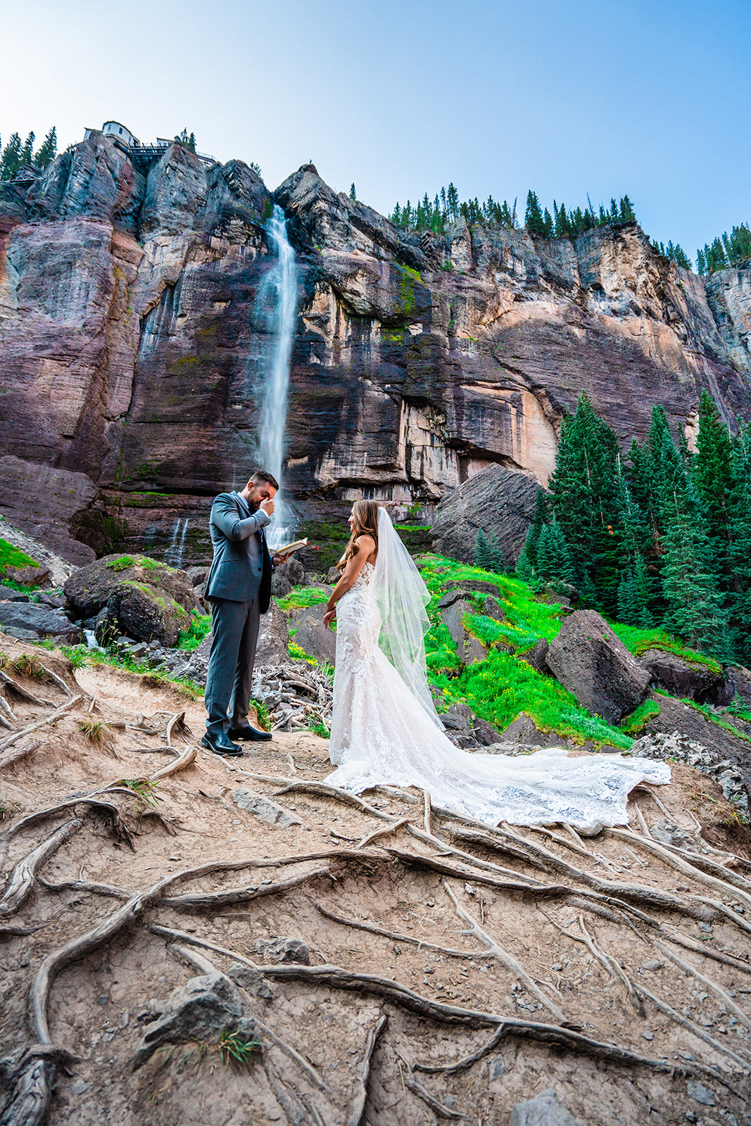 Bride and groom exchanging vows in front of Bridal Veil Falls