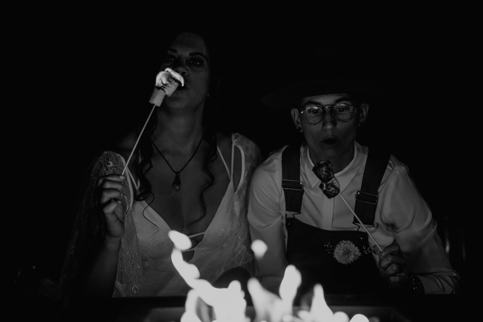 Black and white photo of Lesbian couple making S'mores as their wedding ritual