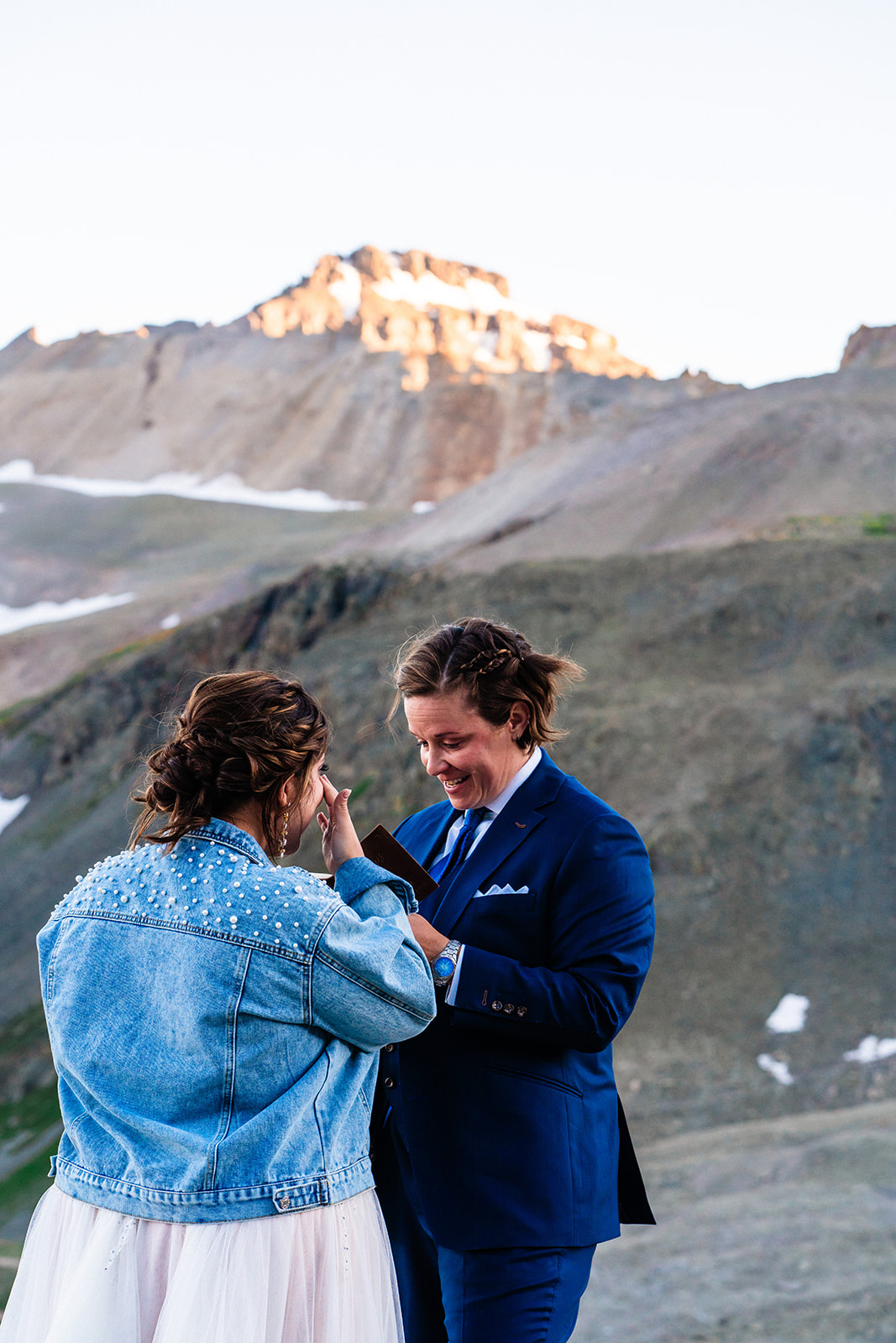Lesbian couple exchanging vows during sunset
