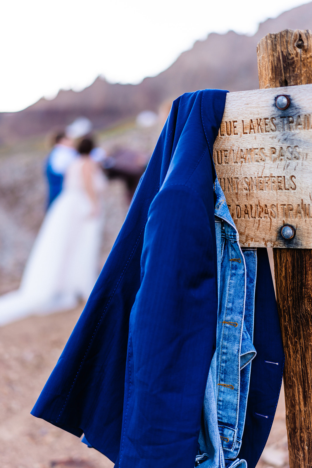 Blue Lakes sign with couples jackets hanging off