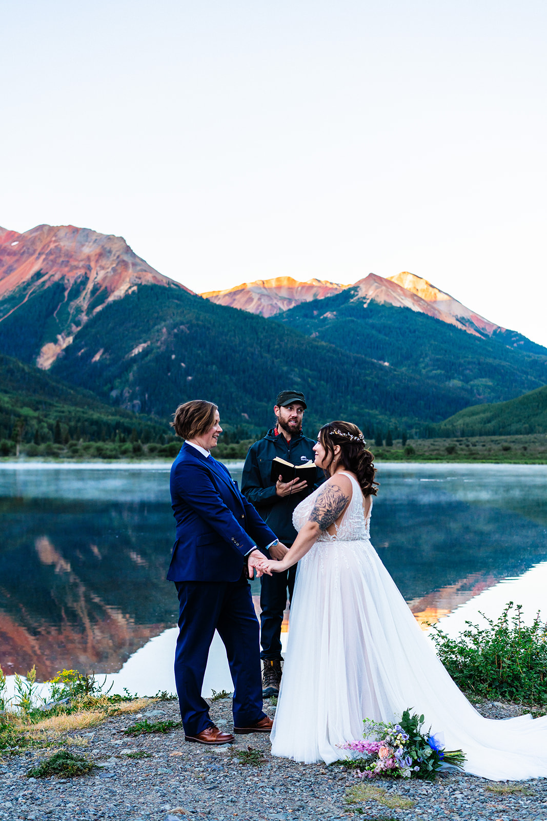 Lesbian couple exchanging vows with officiant