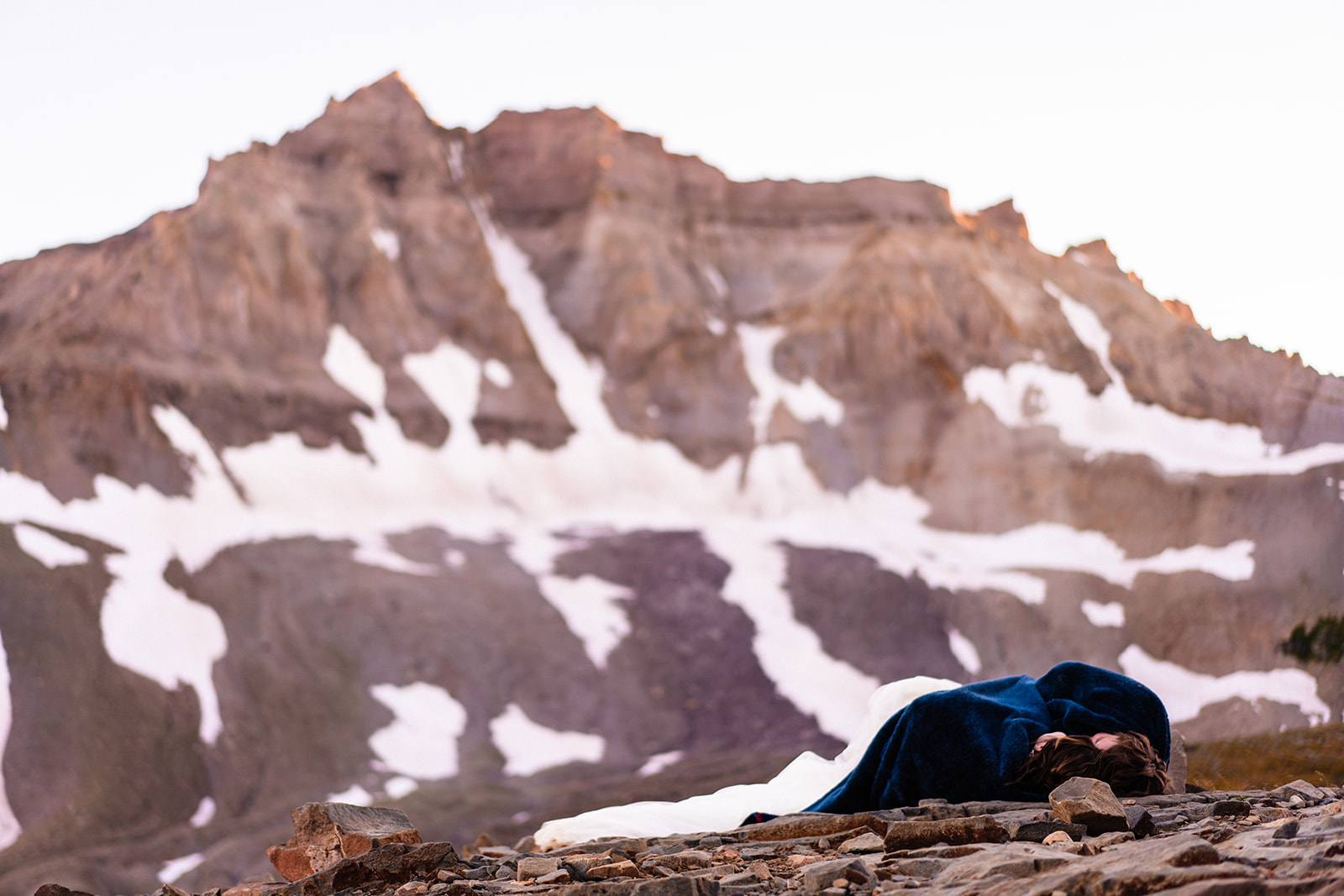 Couple laying down on the ground in the mountains of Colorado