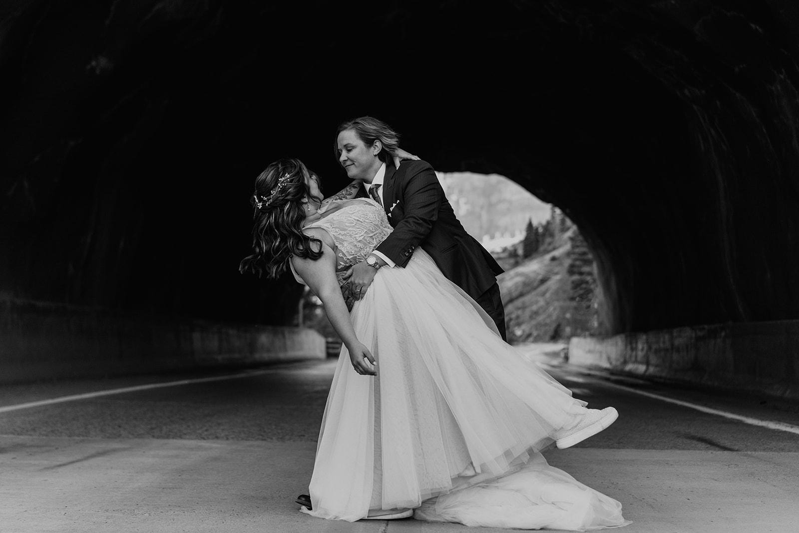 Black and white photo of bride dipping bride
