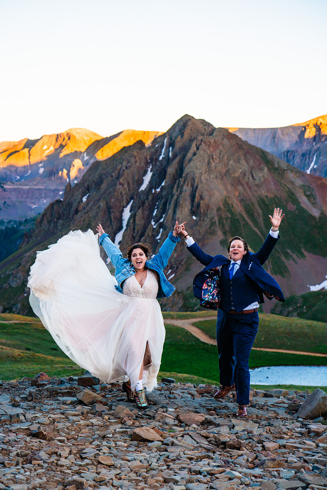 Lesbian couple cheering during sunset in Ouray Colorado