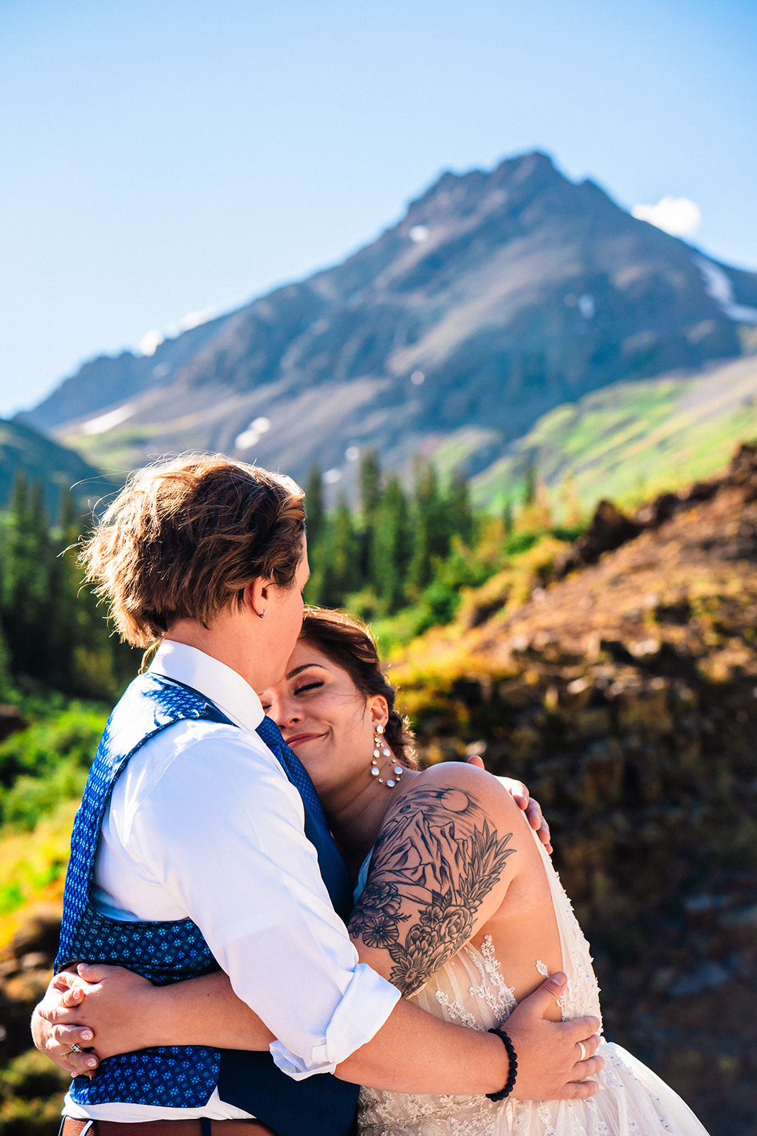 Lesbian couple hugging one another in Ouray Colorado