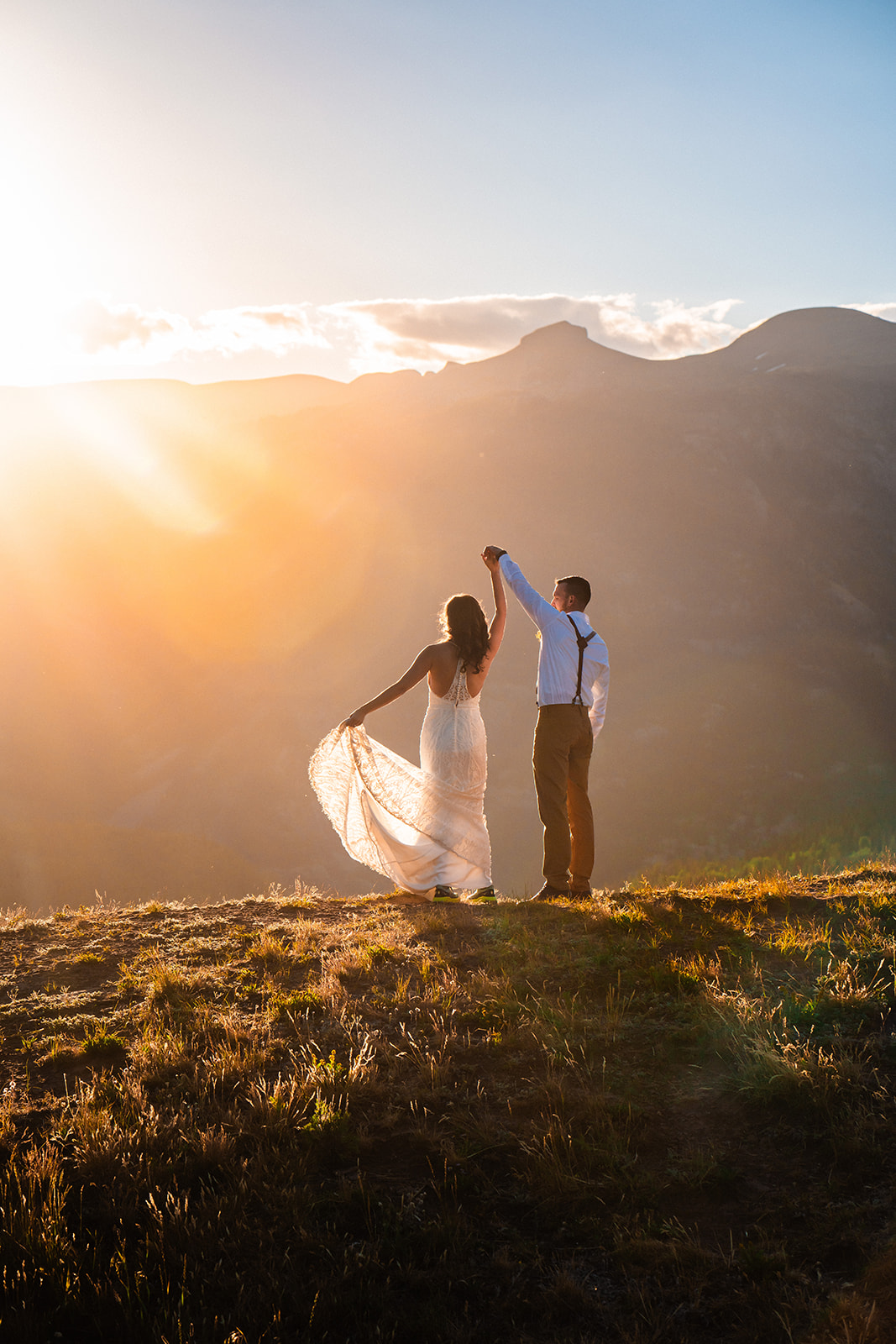 Bride and groom dancing in the mountains of San Juan during the sunrise