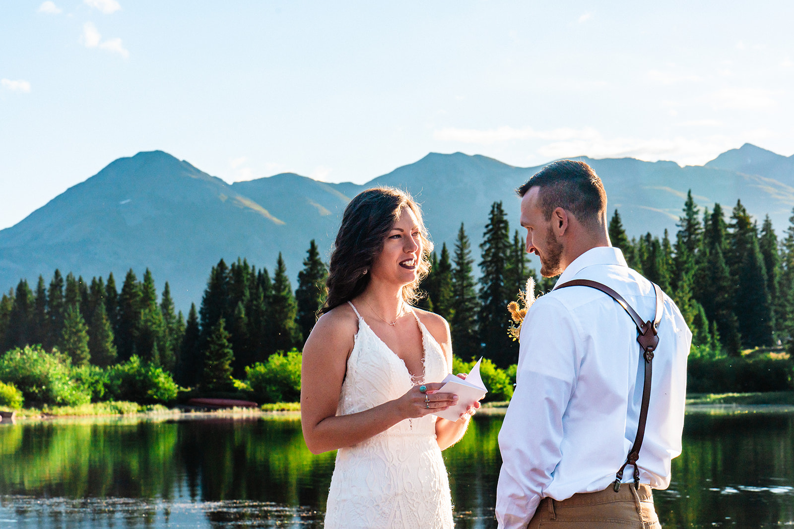 Bride and groom exchanging vows at a shoreline in the San Juan Mountains