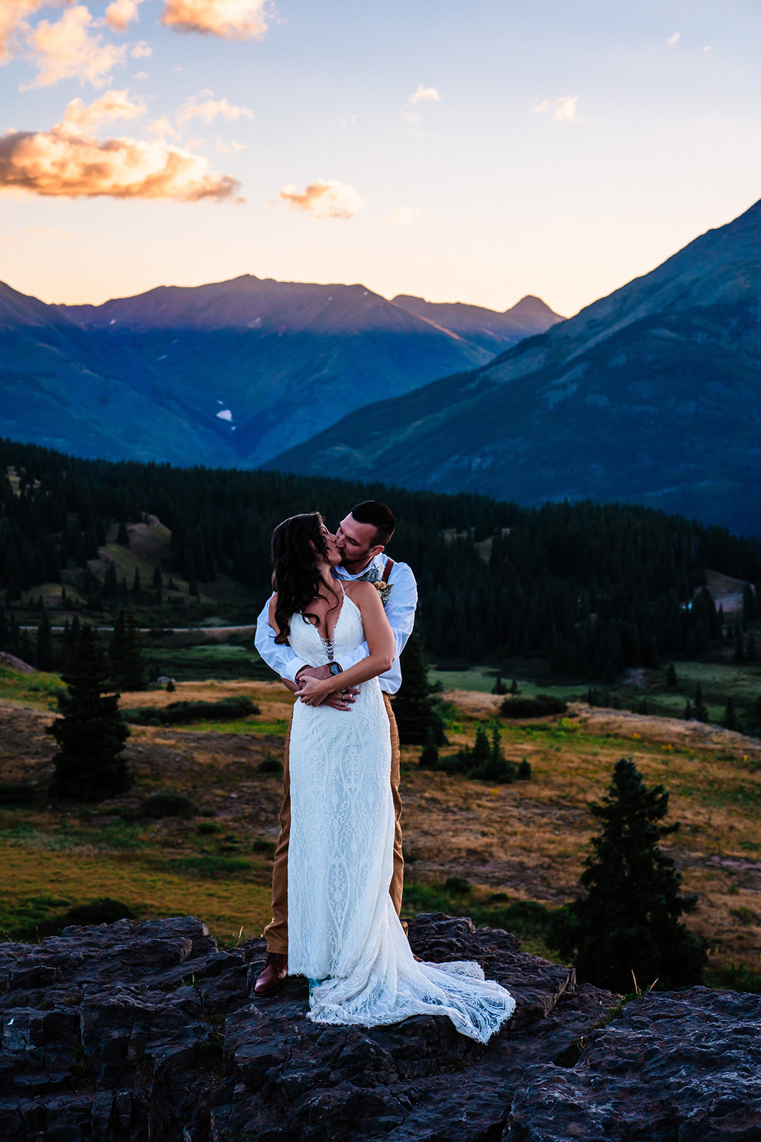 Bride and groom kissing during the sunrise in the San Juan mountains