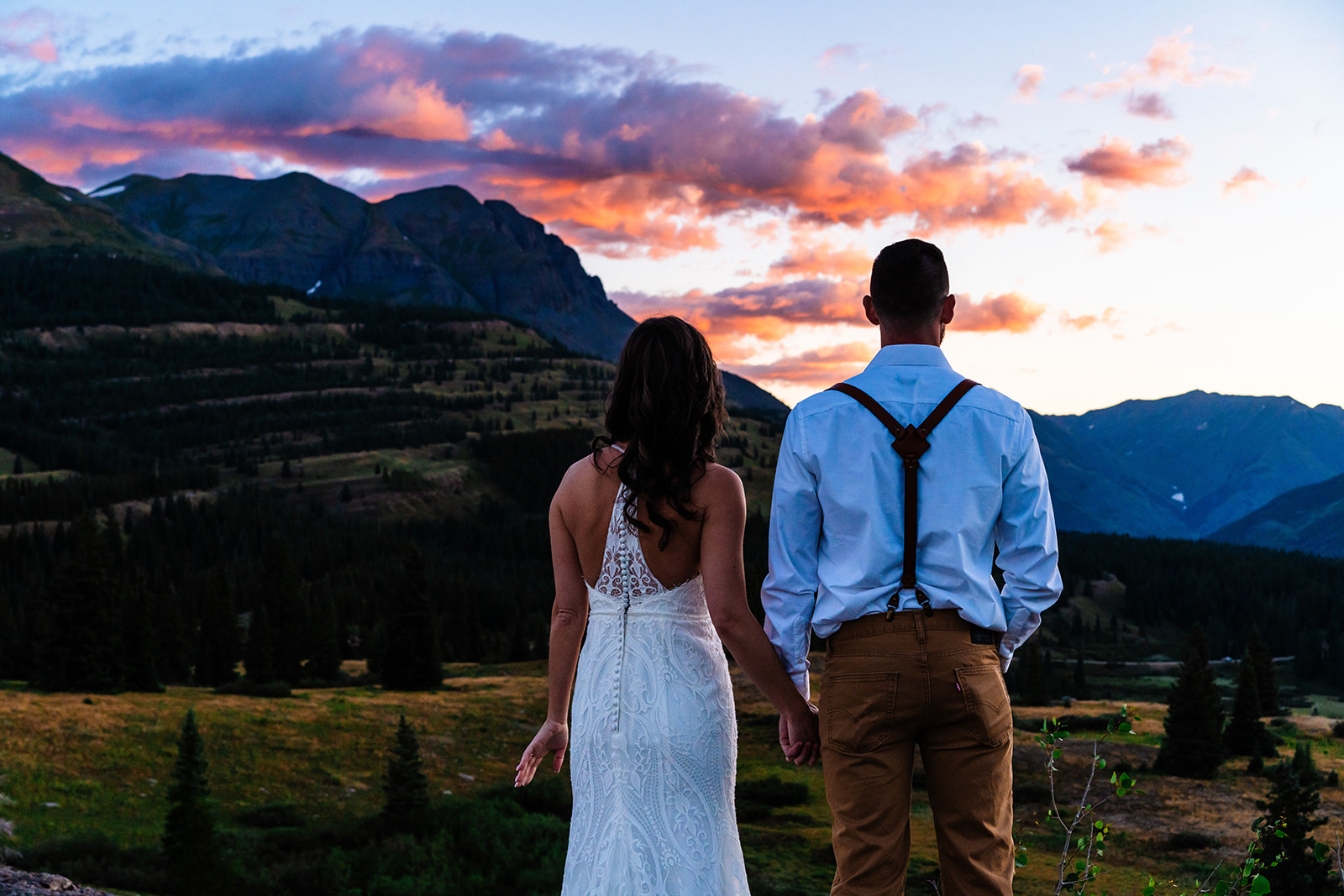 Bride and groom watching the sunrise in the San Juan mountains