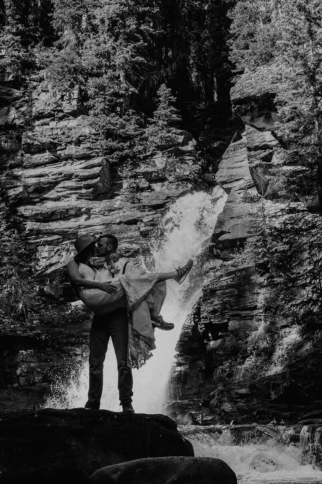 Black and white photo of Adventurous bride and groom in the San Juan mountains near a waterfall