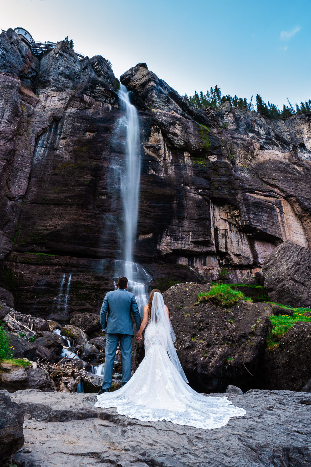 Couple elopes under waterfall during their Bridal Veil Falls elopement in Telluride