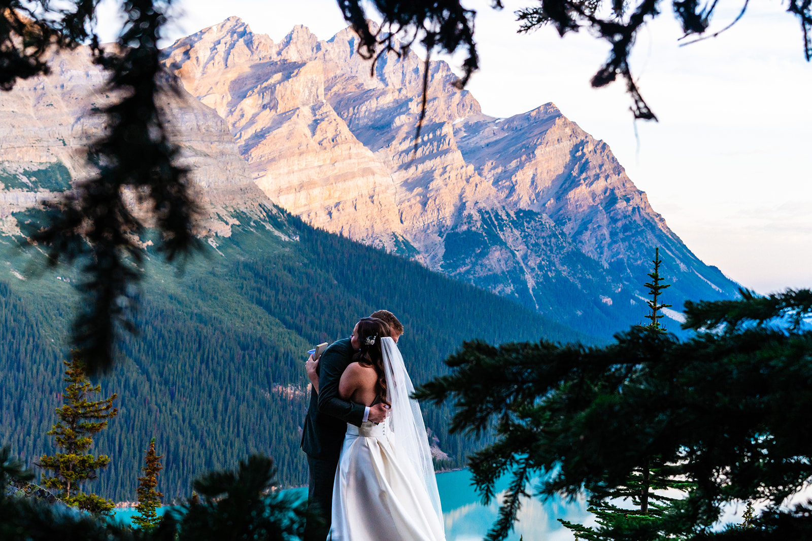 Bride and groom hugging after vow exchange in Banff