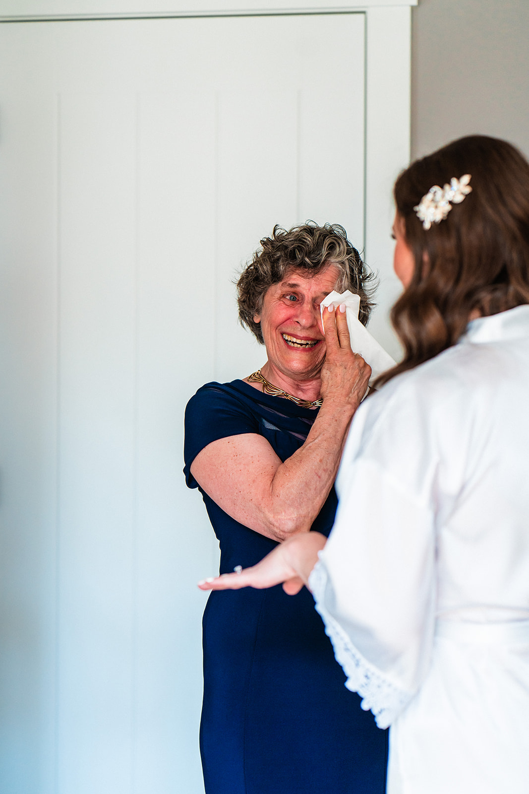 Mother crying seeing bride getting ready