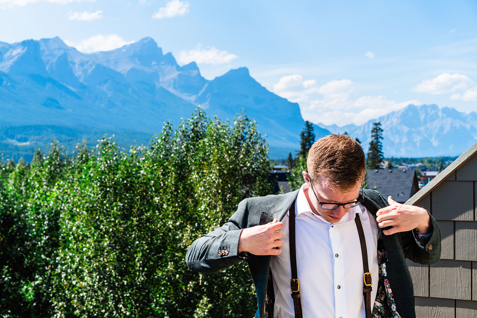 Groom getting ready in the mountains of Banff