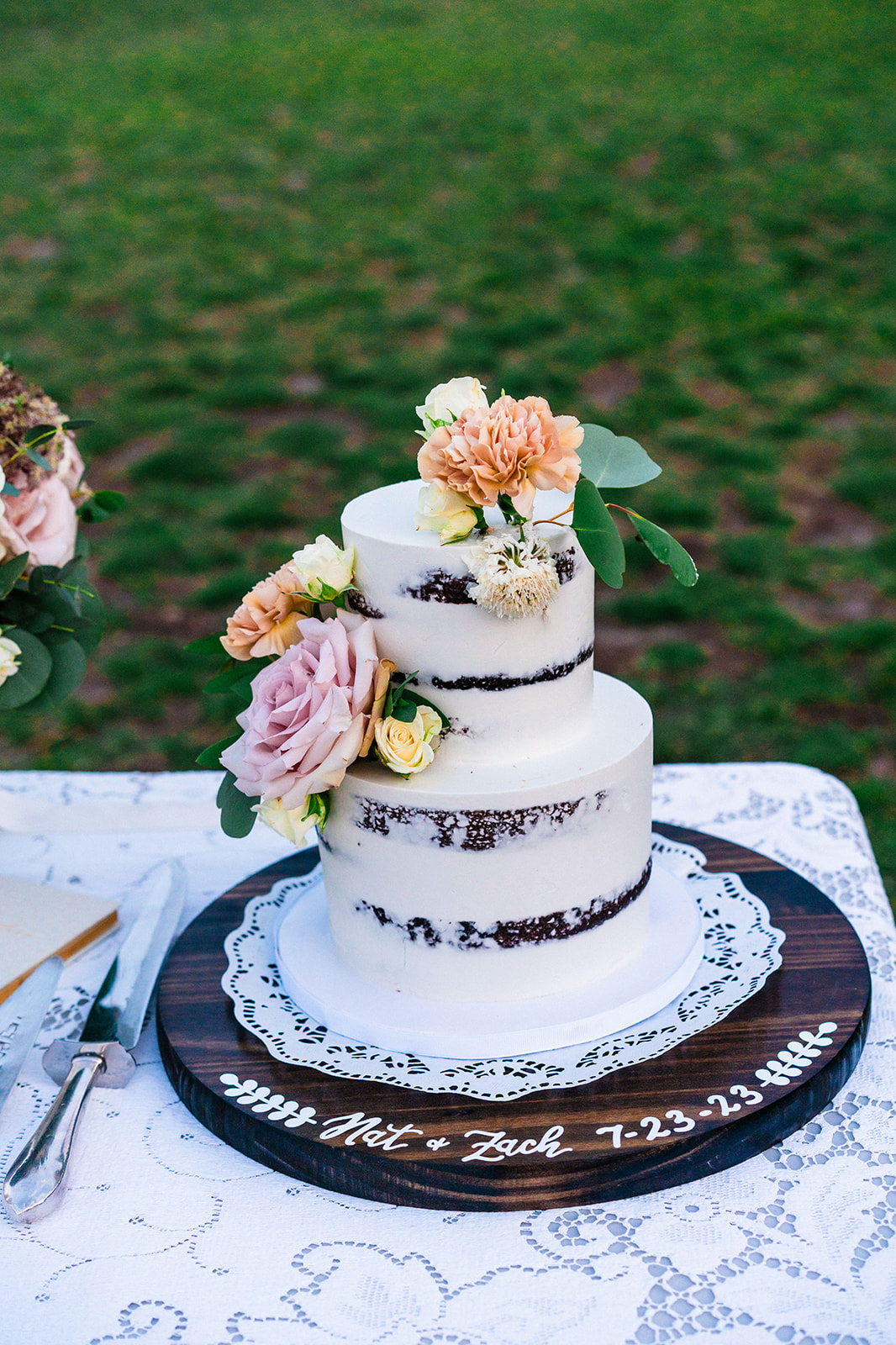 Simple white wedding cake with pink and orange flowers