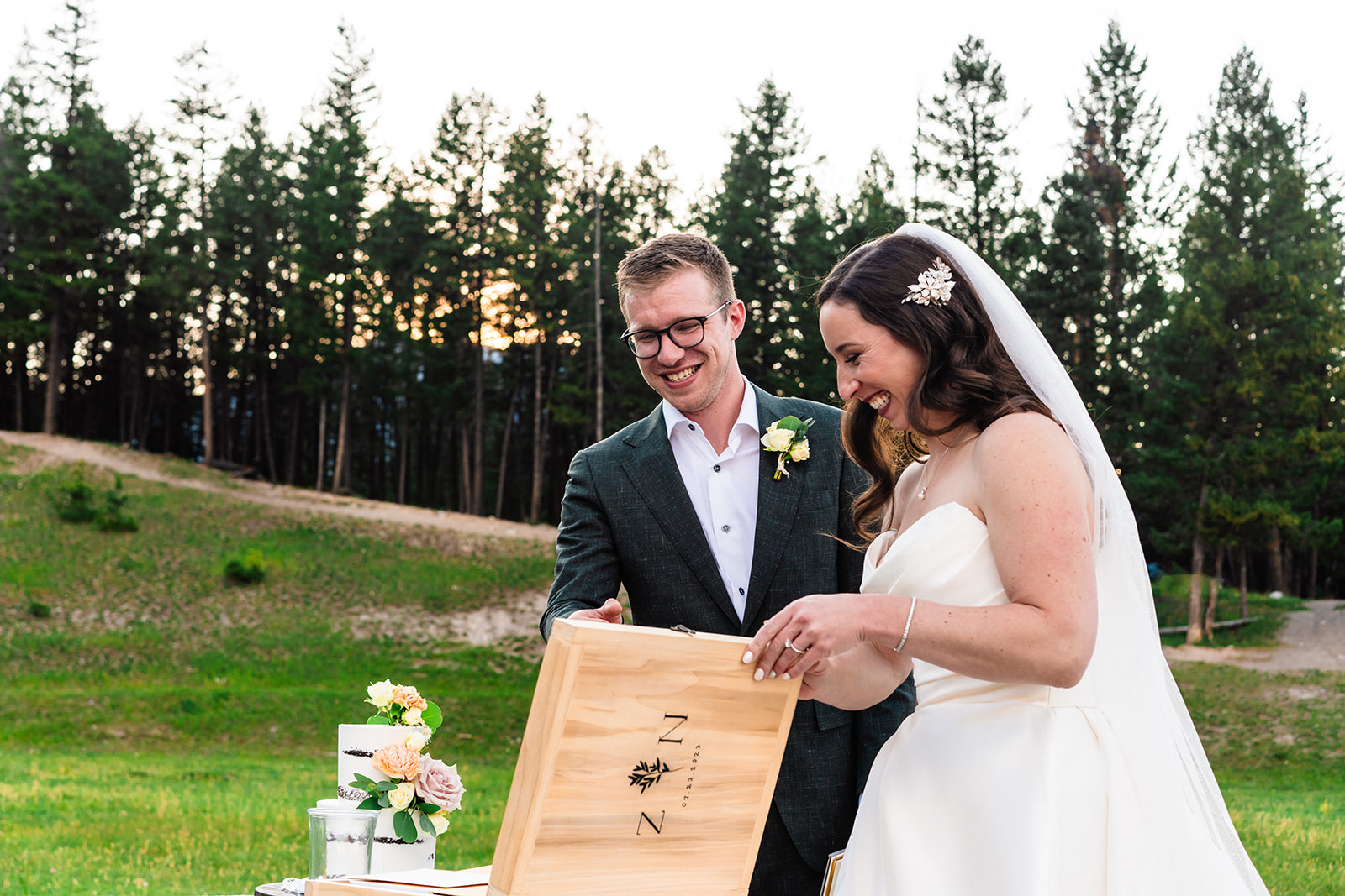 Bride and groom looking at wooden time capsule