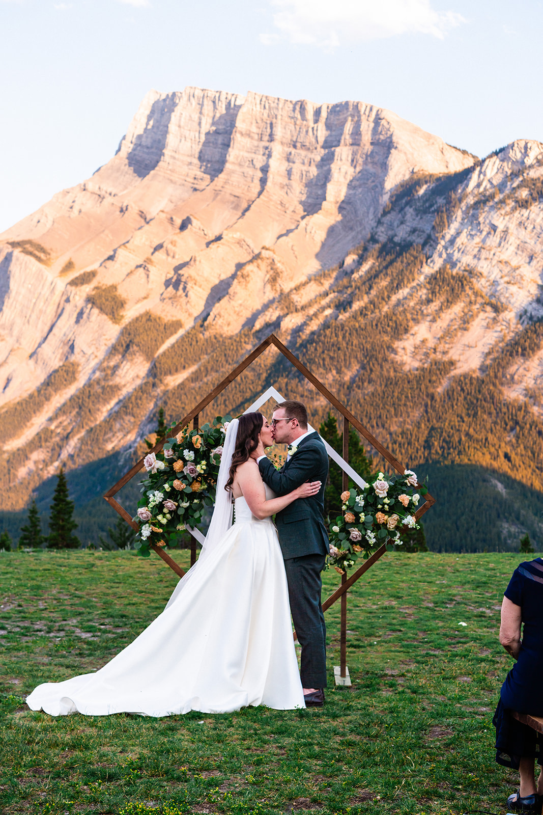 Bride and groom sealing a kiss after their Banff wedding ceremony