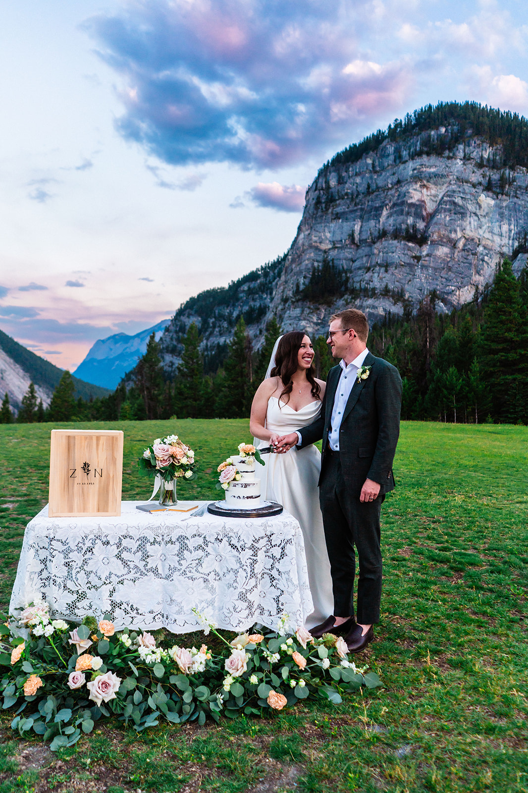 Bride and groom cutting cake for their Banff Wedding
