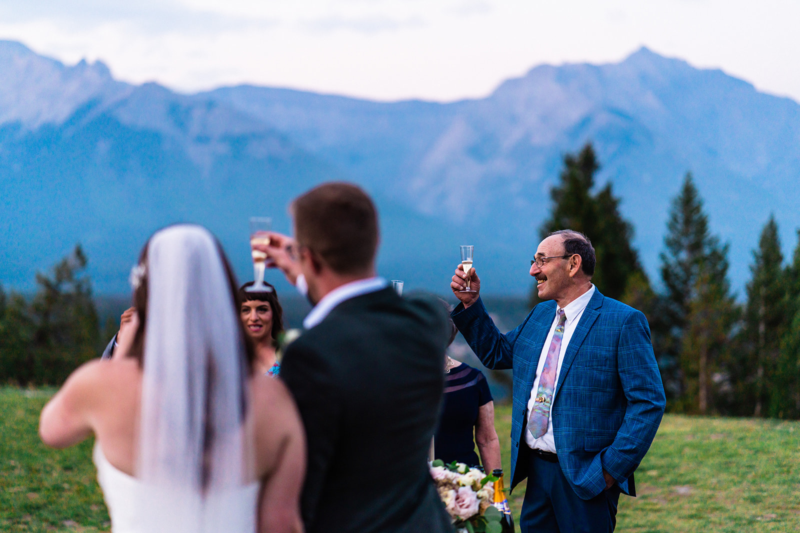 Bride and grooms family and friends toasting to their intimate wedding in Banff