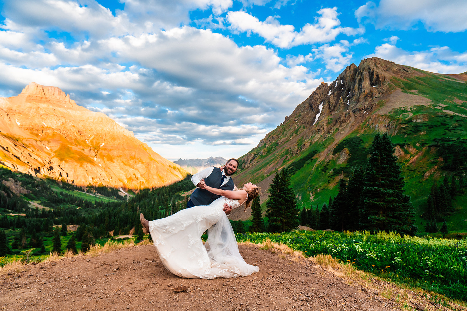 Groom dipping bride at Yankee Boy Basin for during elopement and wedding