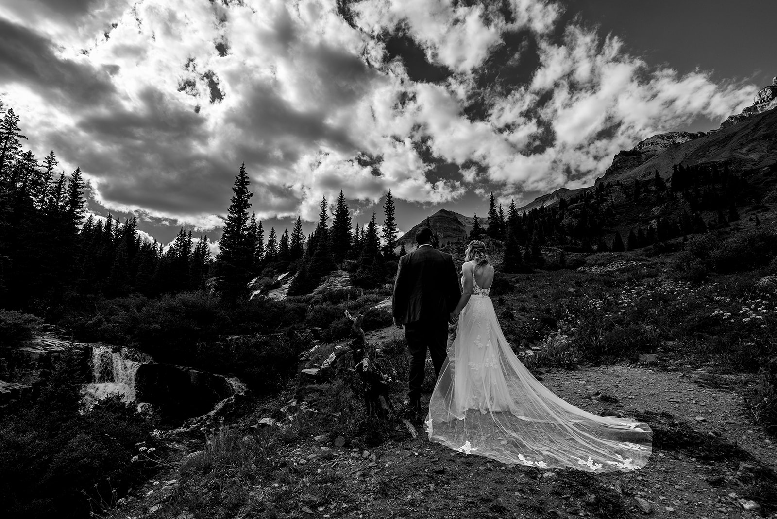 Black and white photo of bride and groom looking off into the distance at Yankee Boy Basin