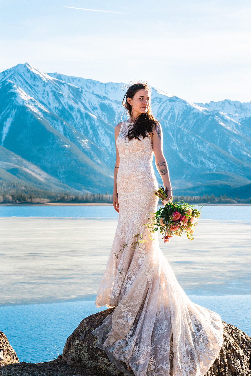 Stunning bride posing in front of Twin Lakes in a beautiful lace A-line elopement dress