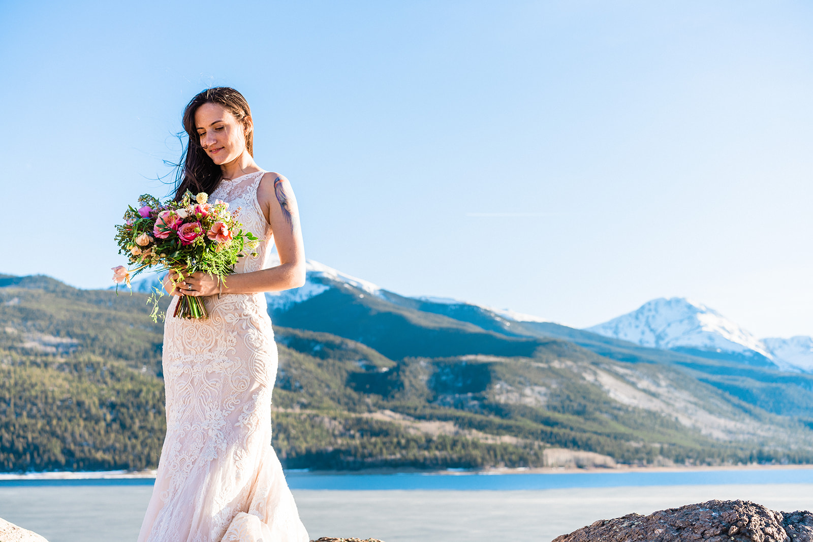 Stunning bride posing in front of Twin Lakes in a beautiful lace A-line elopement dress
