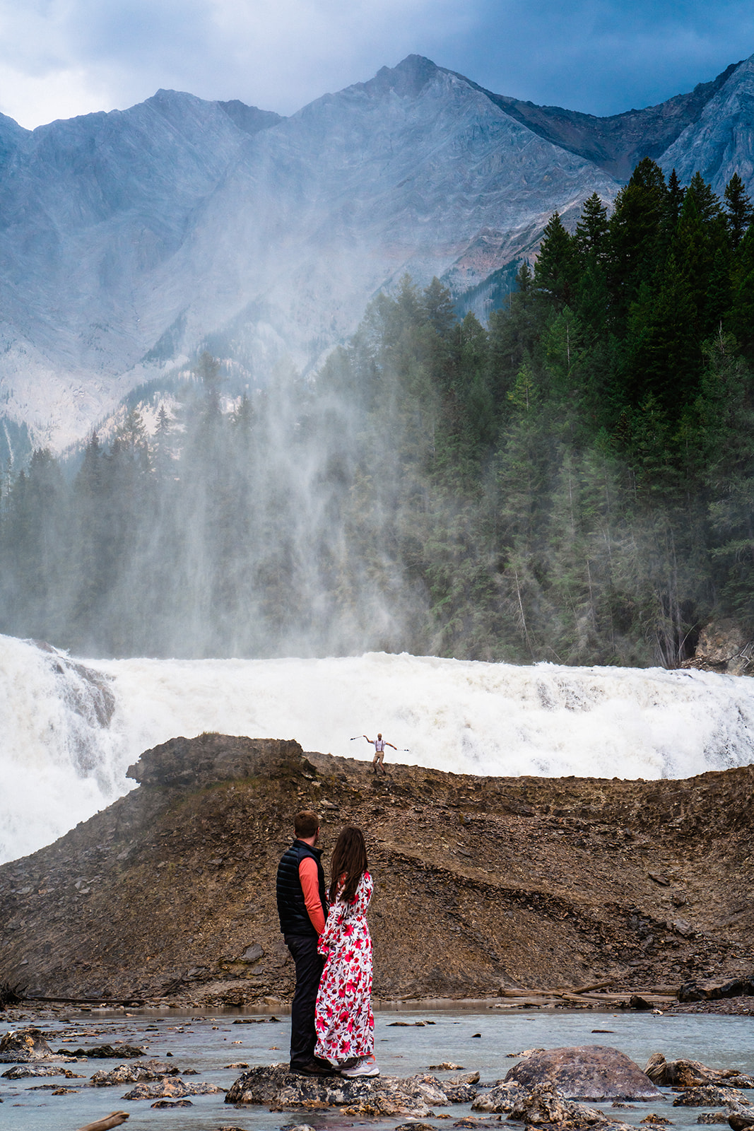 Bride and groom posing near waterfalls in Yoho National Park in Canada