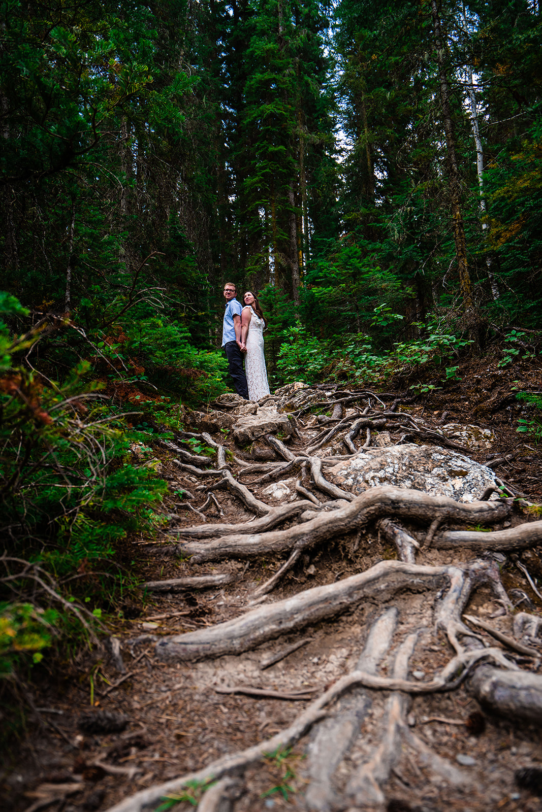Bride and groom posing in the forests of Yoho National Park in Canada