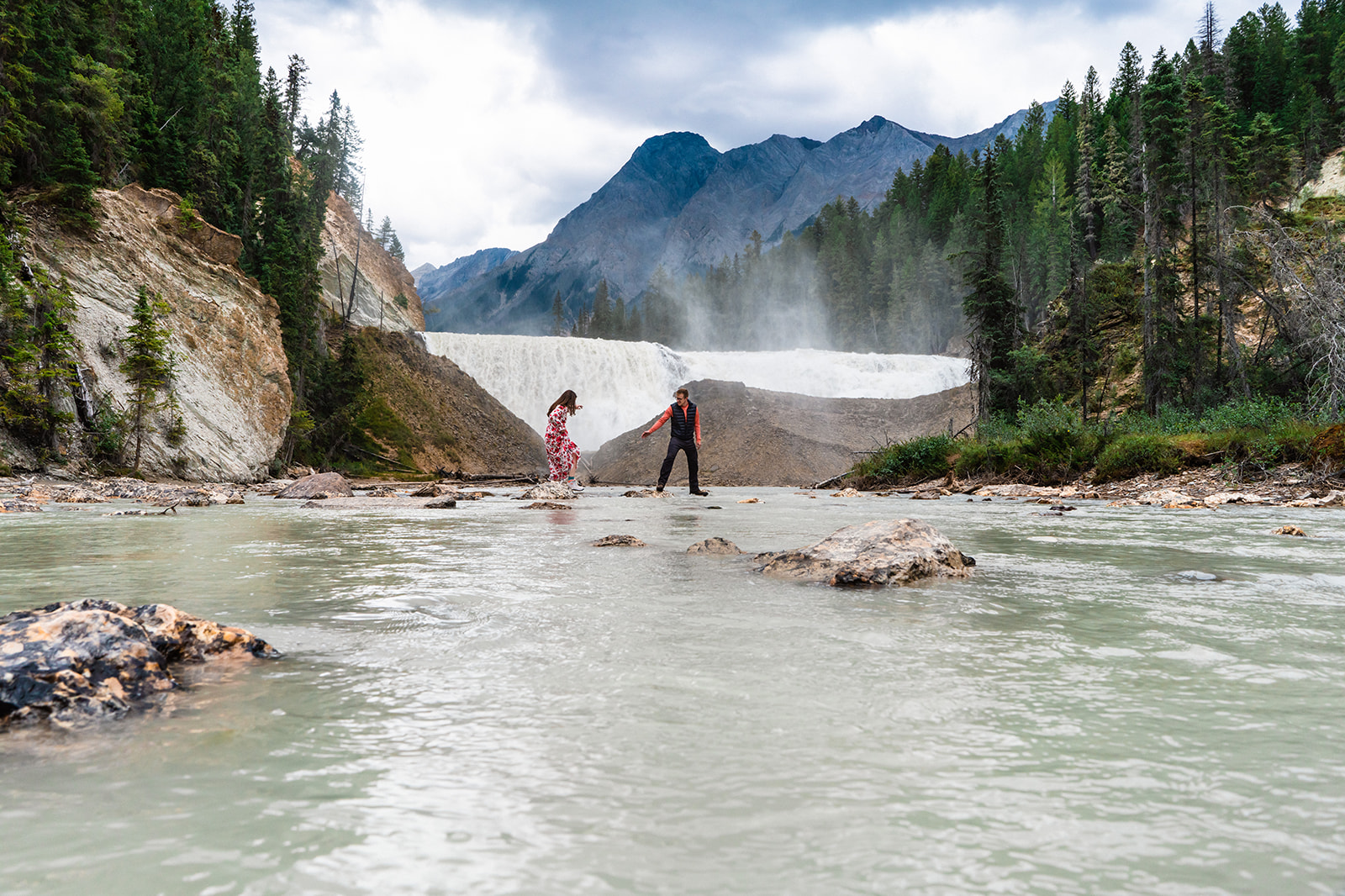 Bride and groom exploring the waterfalls in Yoho National Park elopement