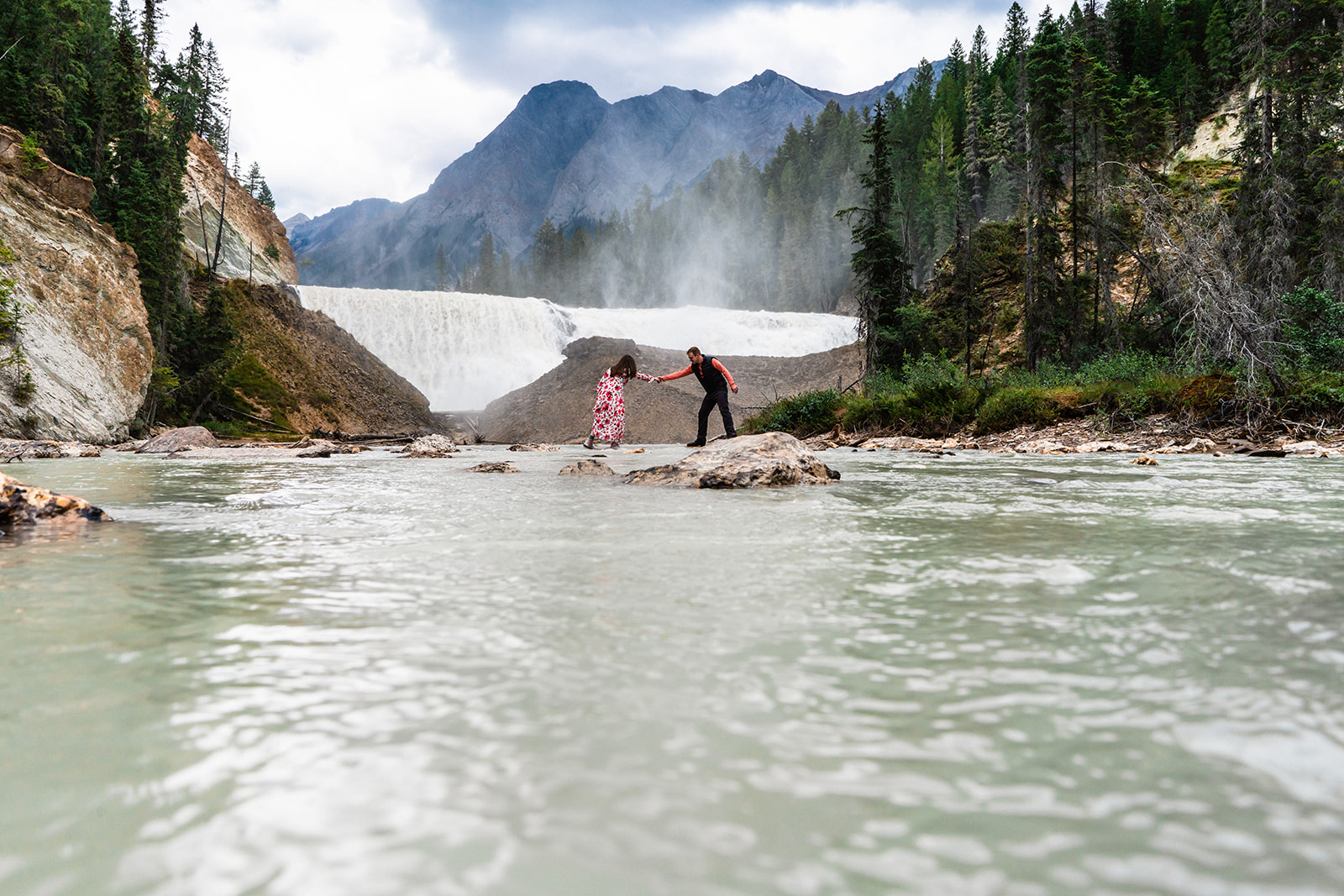 Bride and groom exploring the waterfalls in Yoho National Park elopement