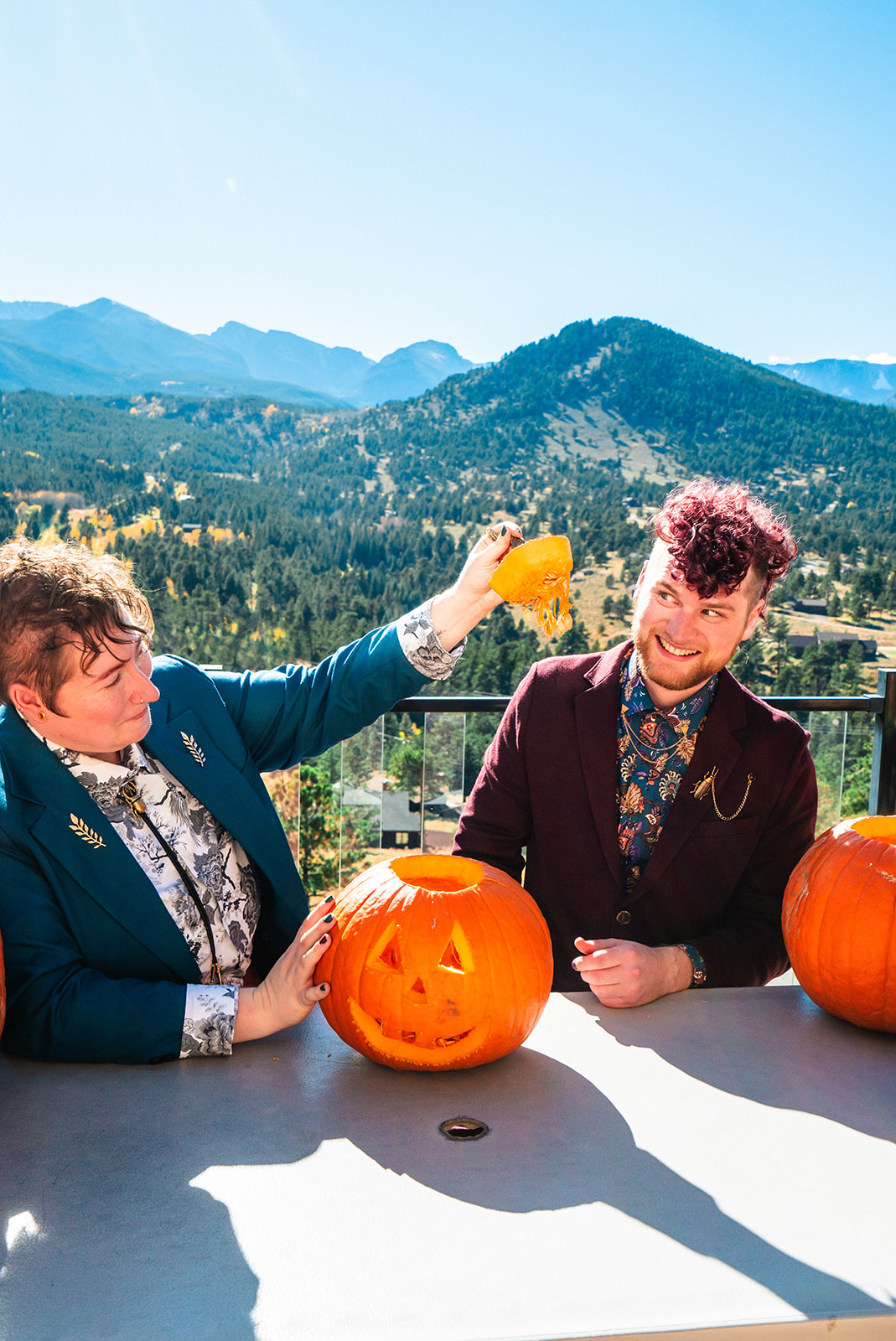 Newlyweds carving pumpkins during their Fall Brainard Lake elopement