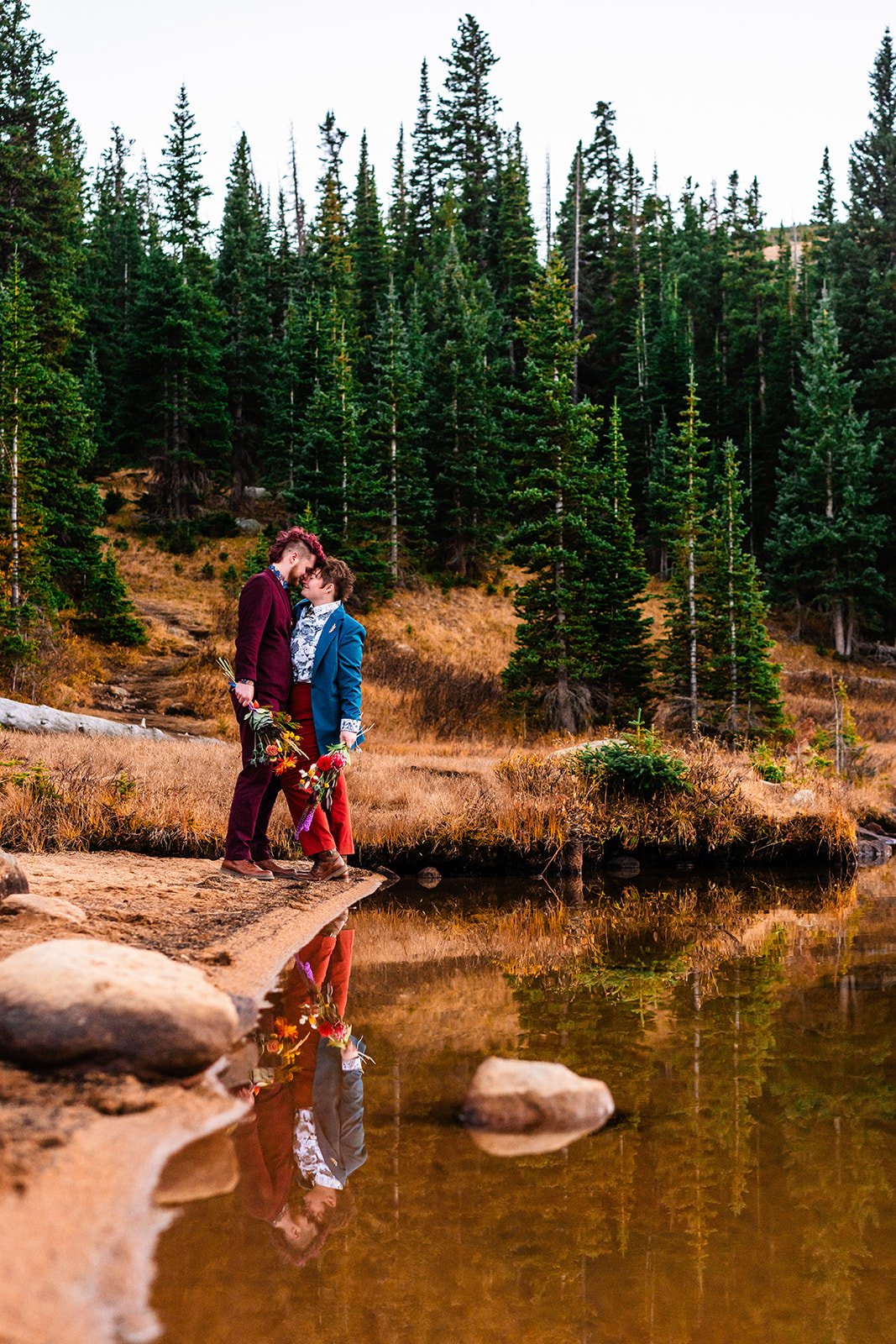 Newlyweds looking at one another endearingly next to Brainard lake