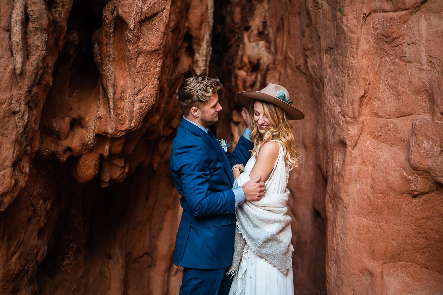A couple exchanging vows in a breathtaking red rock canyon, captured in stunning elopement photos.