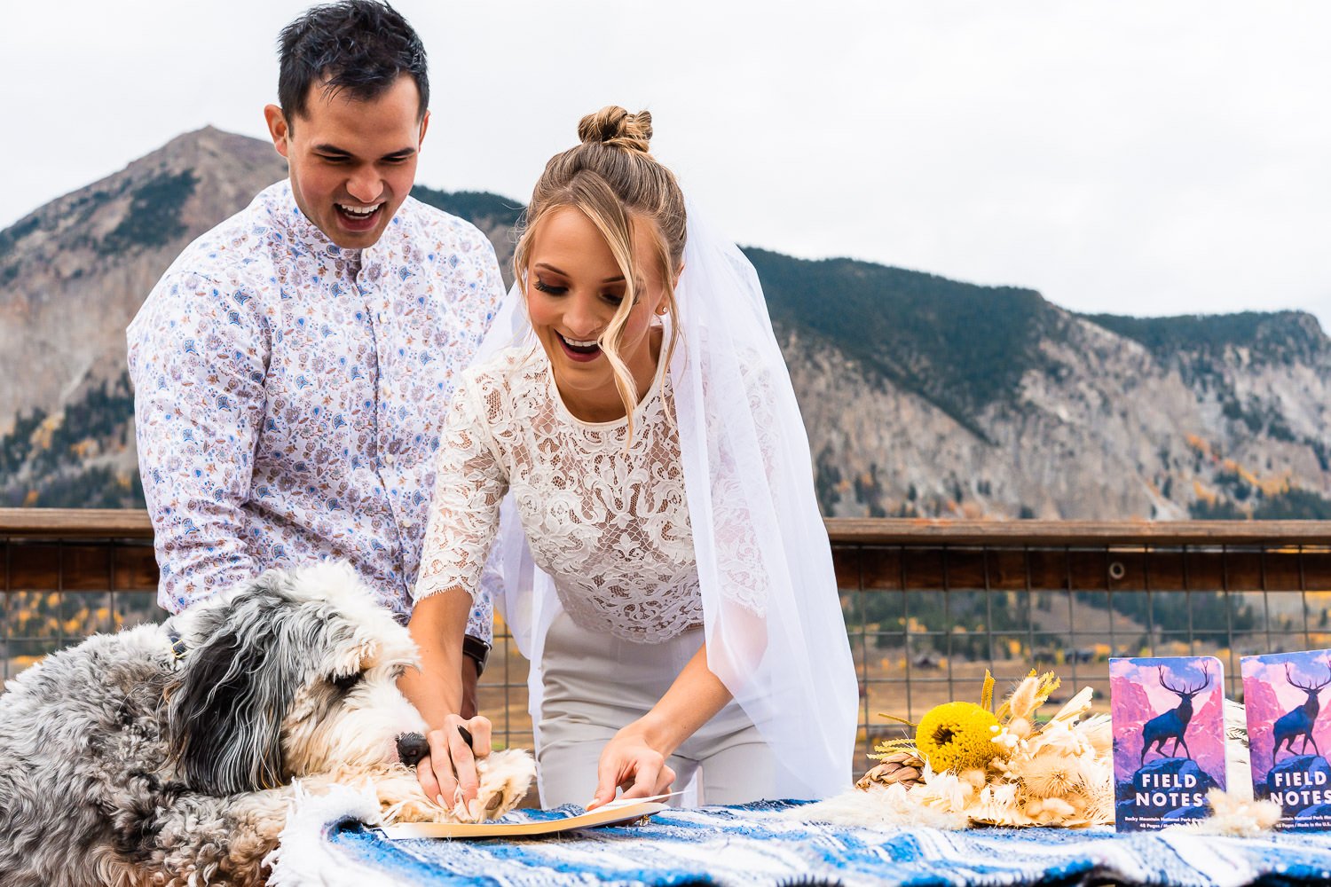 A man and woman capturing elopement photos with their beloved dog.