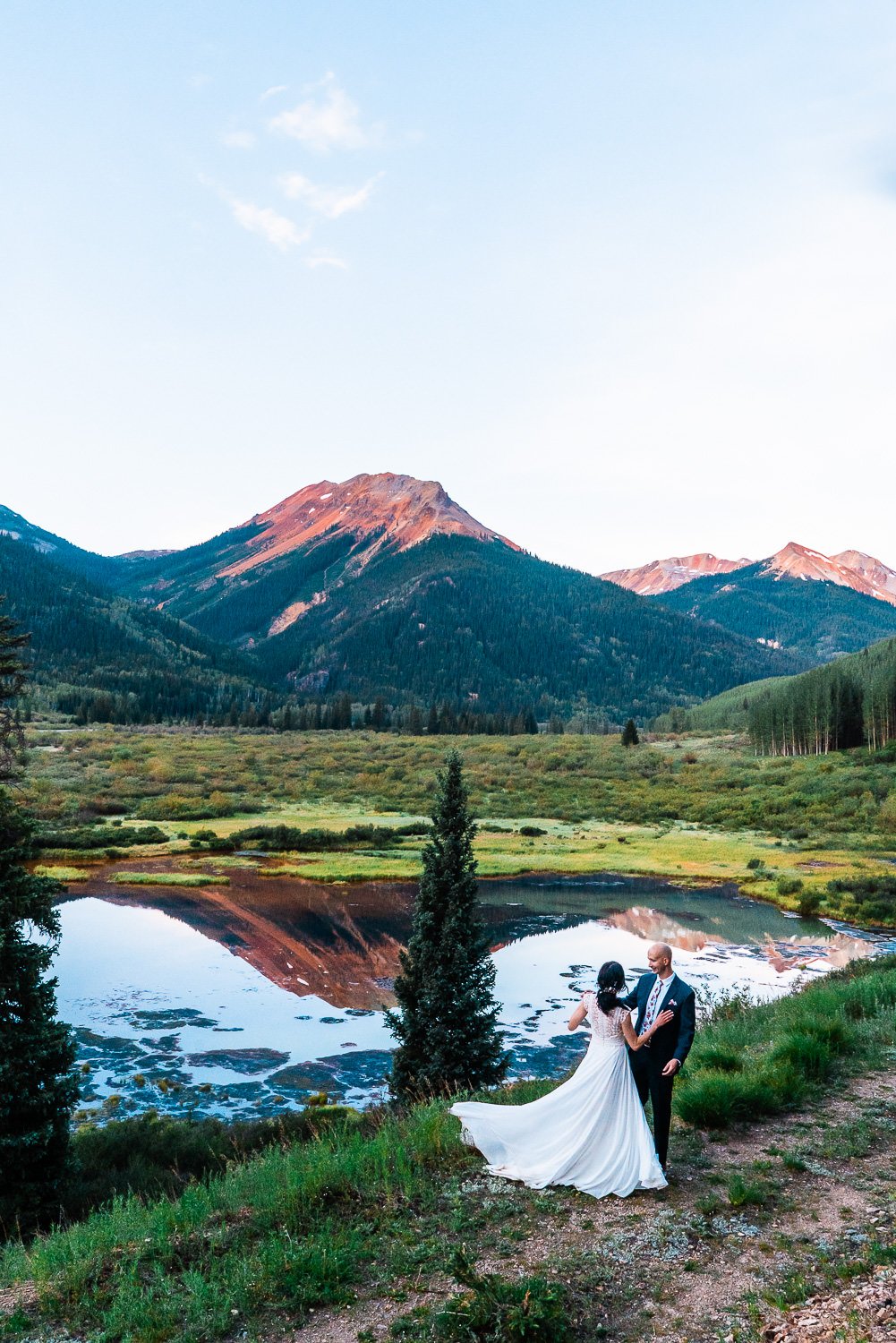 Keywords: elopement photos

Description: A couple's elopement photos captured the magical moment as they stood next to a picturesque lake, with majestic mountains forming a breathtaking backdrop.