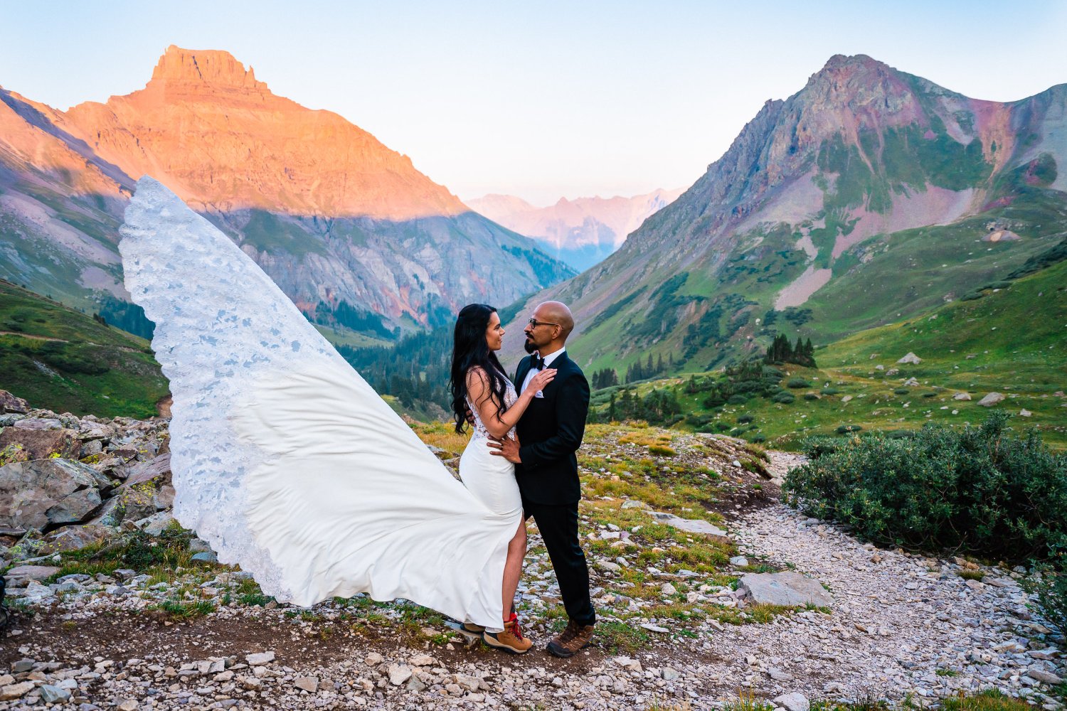 A couple poses for elopement photos in the mountains.