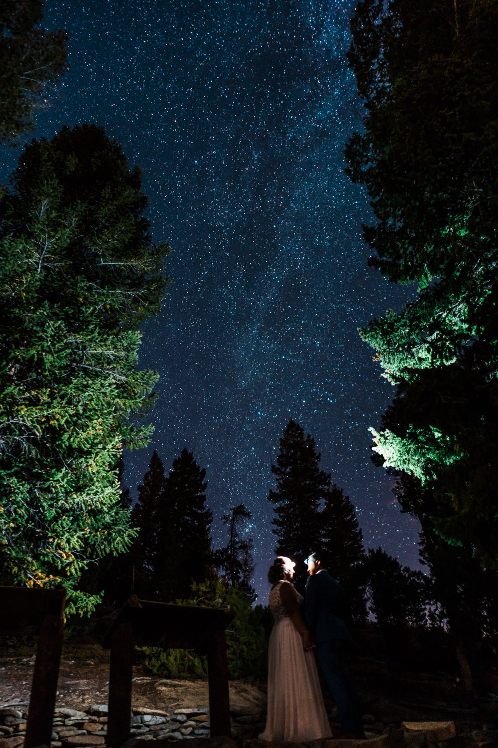 Elopement photos of a bride and groom standing under the stars at a Lake Tahoe wedding.