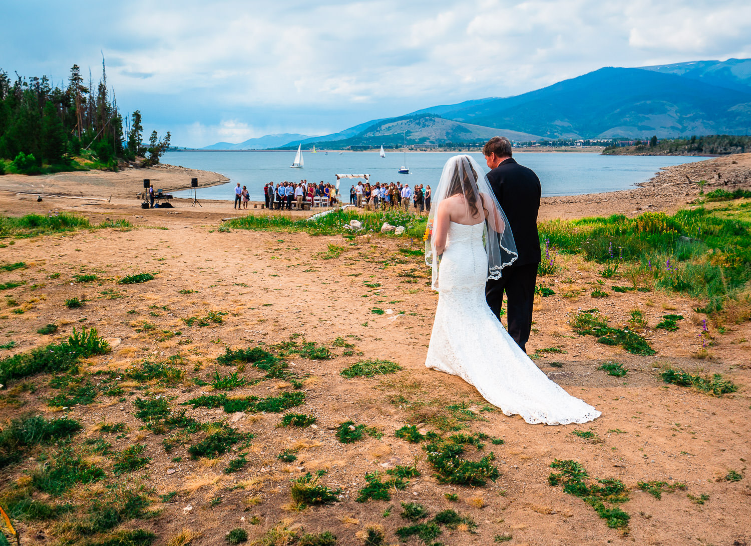 A bride and groom walk to their ceremony altar during their Windy Point Campground Wedding
