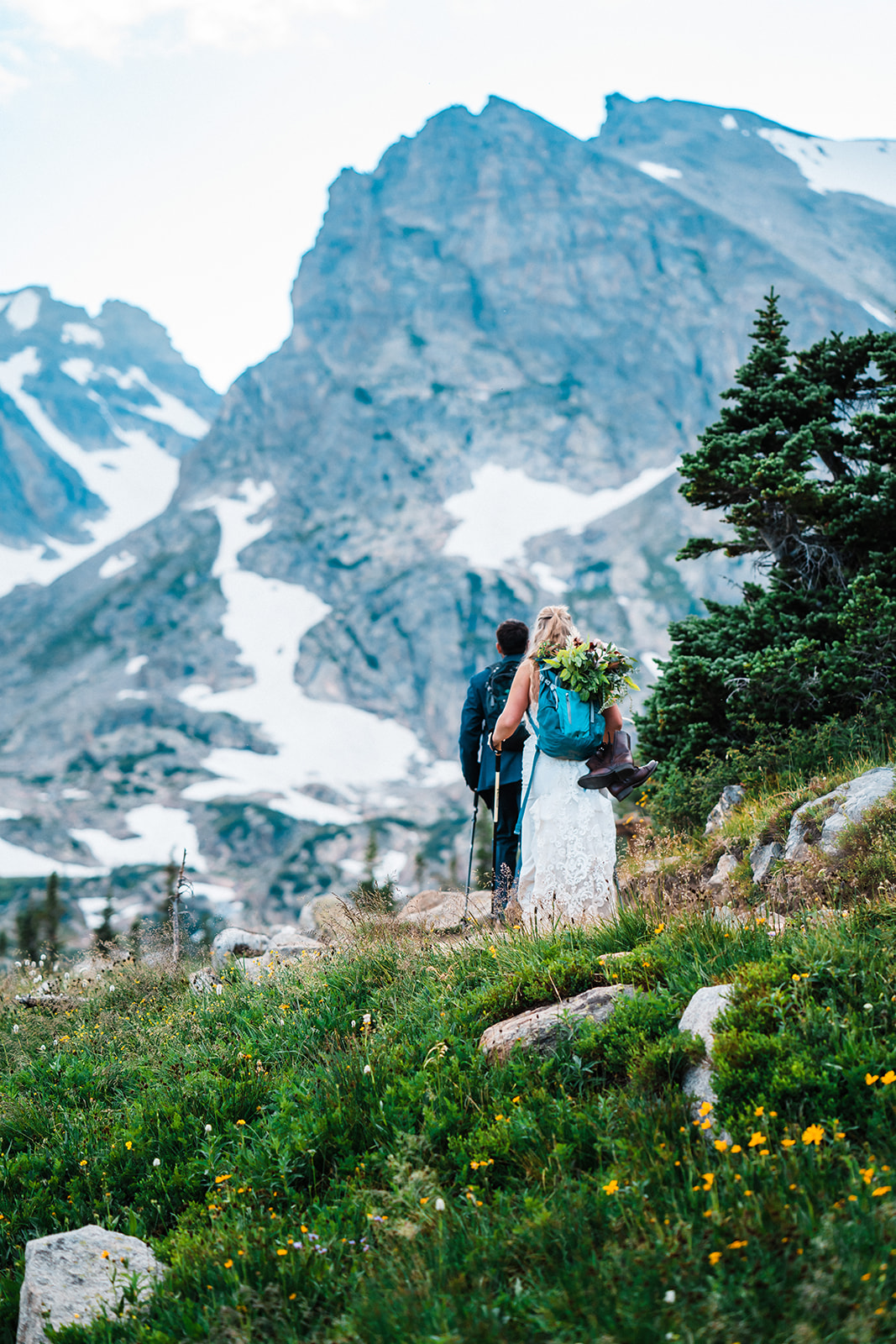 Newlyweds hike along a trail in one of the best places to elope in Colorado during their Brainard Lake Recreation Area elopement.