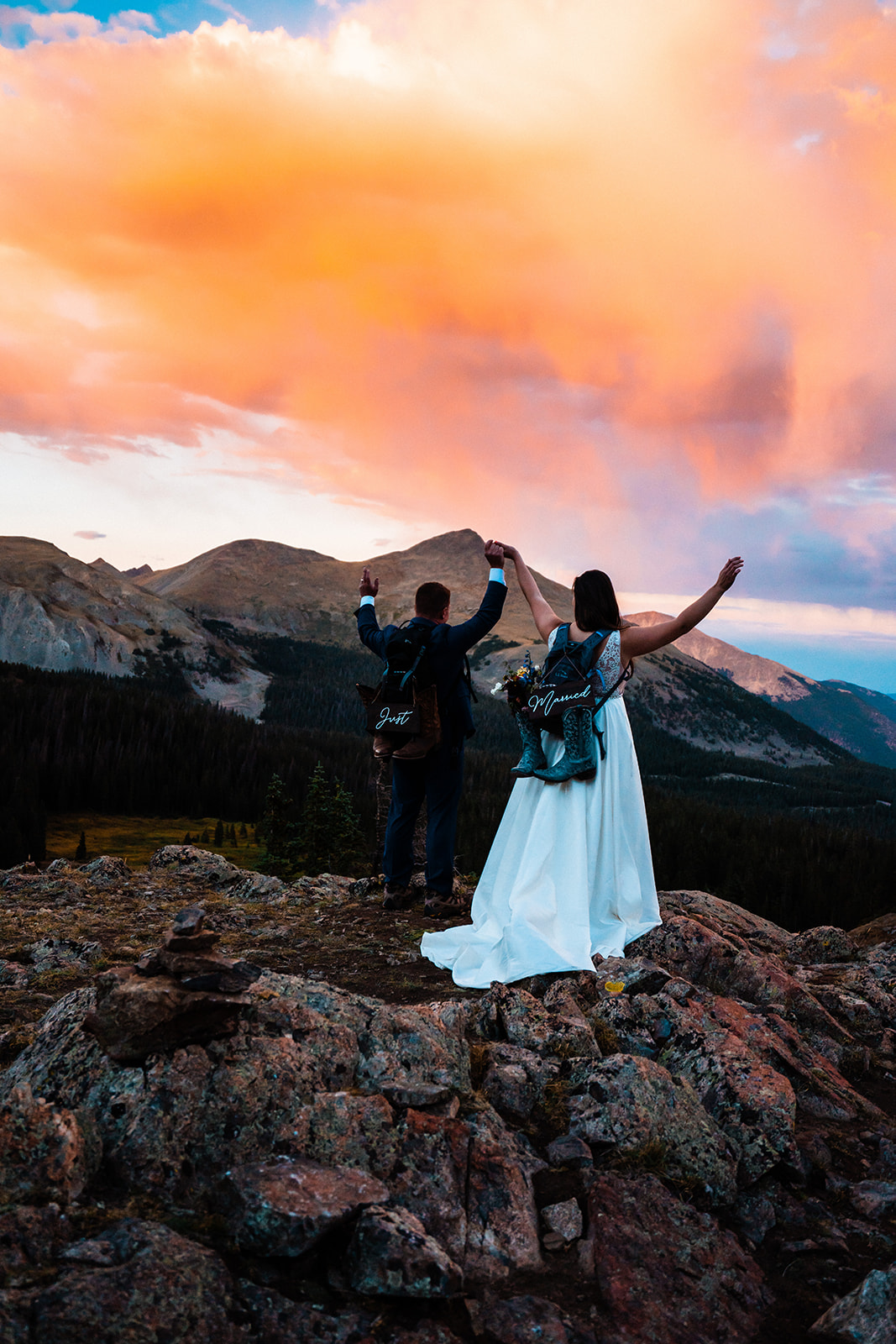 A bride and groom standing on top of a mountain at sunset in one of the best places to elope in Colorado during their Buena Vista elopement.