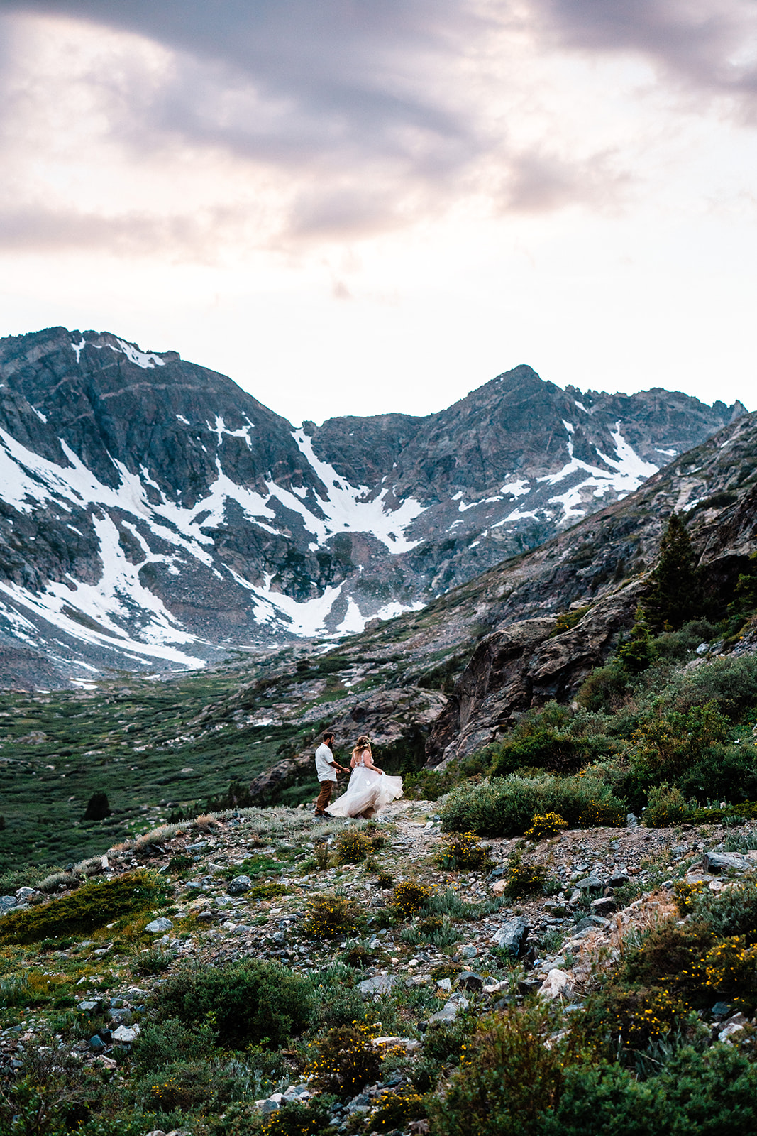 A bride and groom explore a trail in one of the best places to elope in Colorado during their Breckenridge elopement.