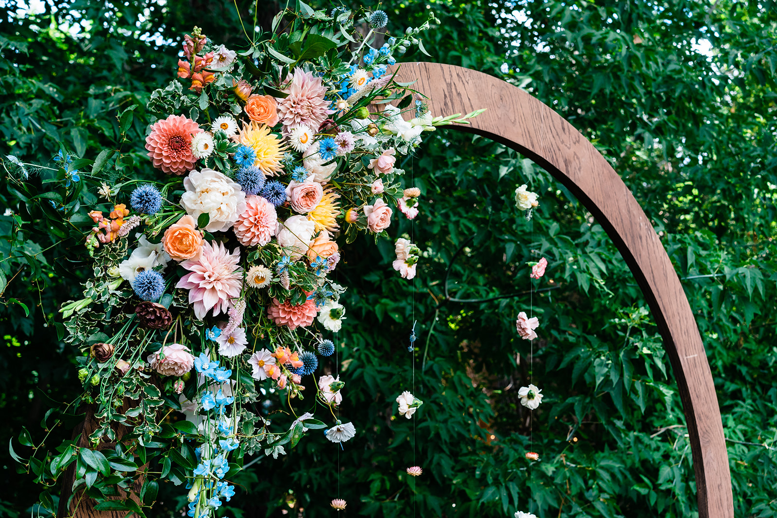 A wooden arch adorned with vibrant flowers perfect for a Telluride elopement.