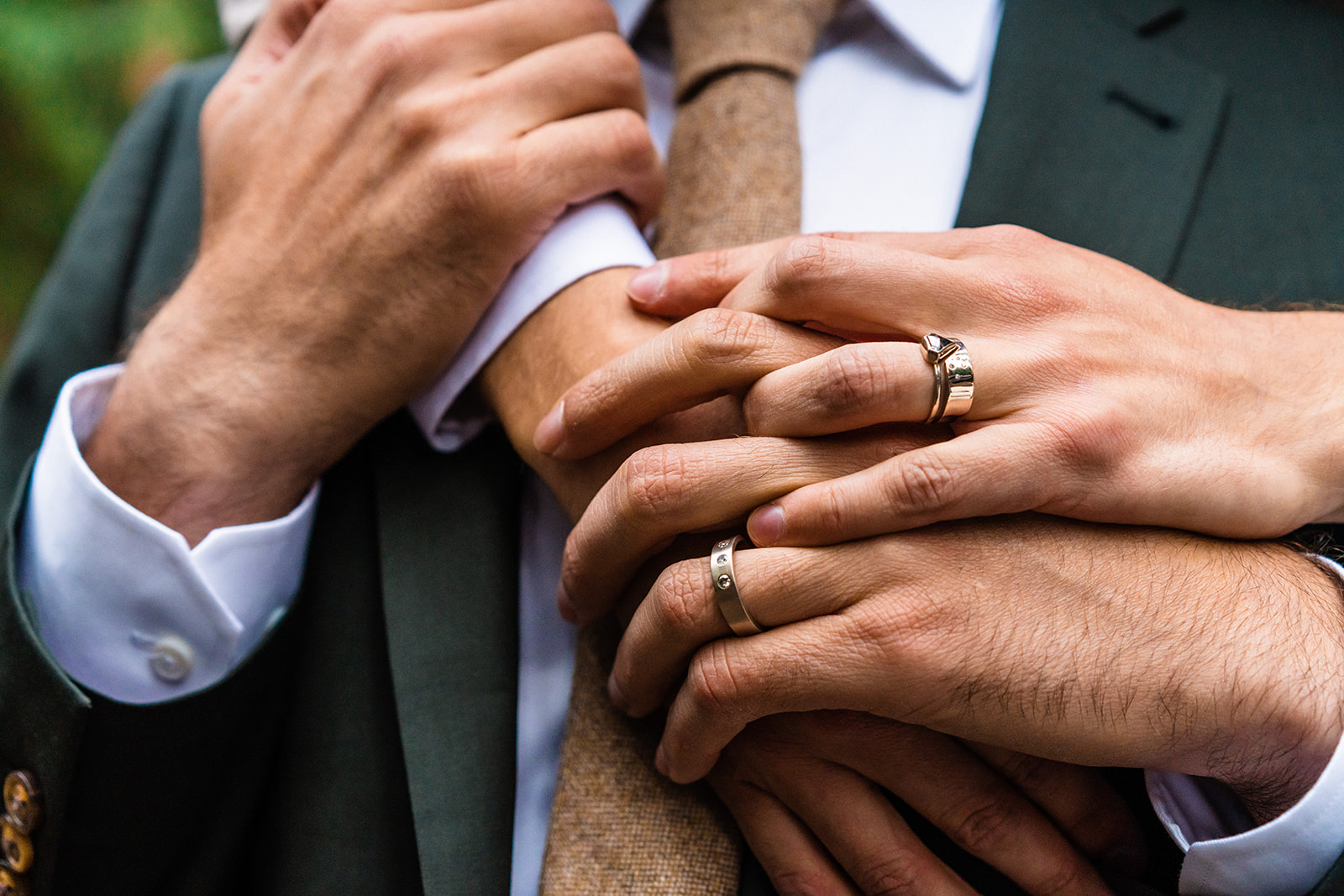 A close up of hands with wedding rings on each other.