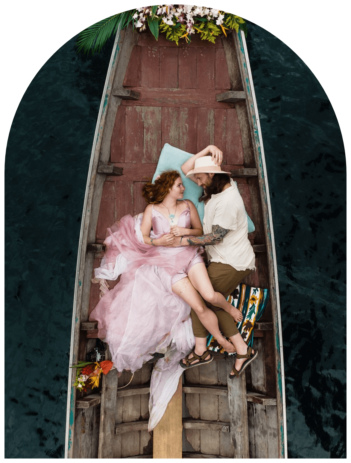 meg and kevin lying in a boat during their adventure elopement
