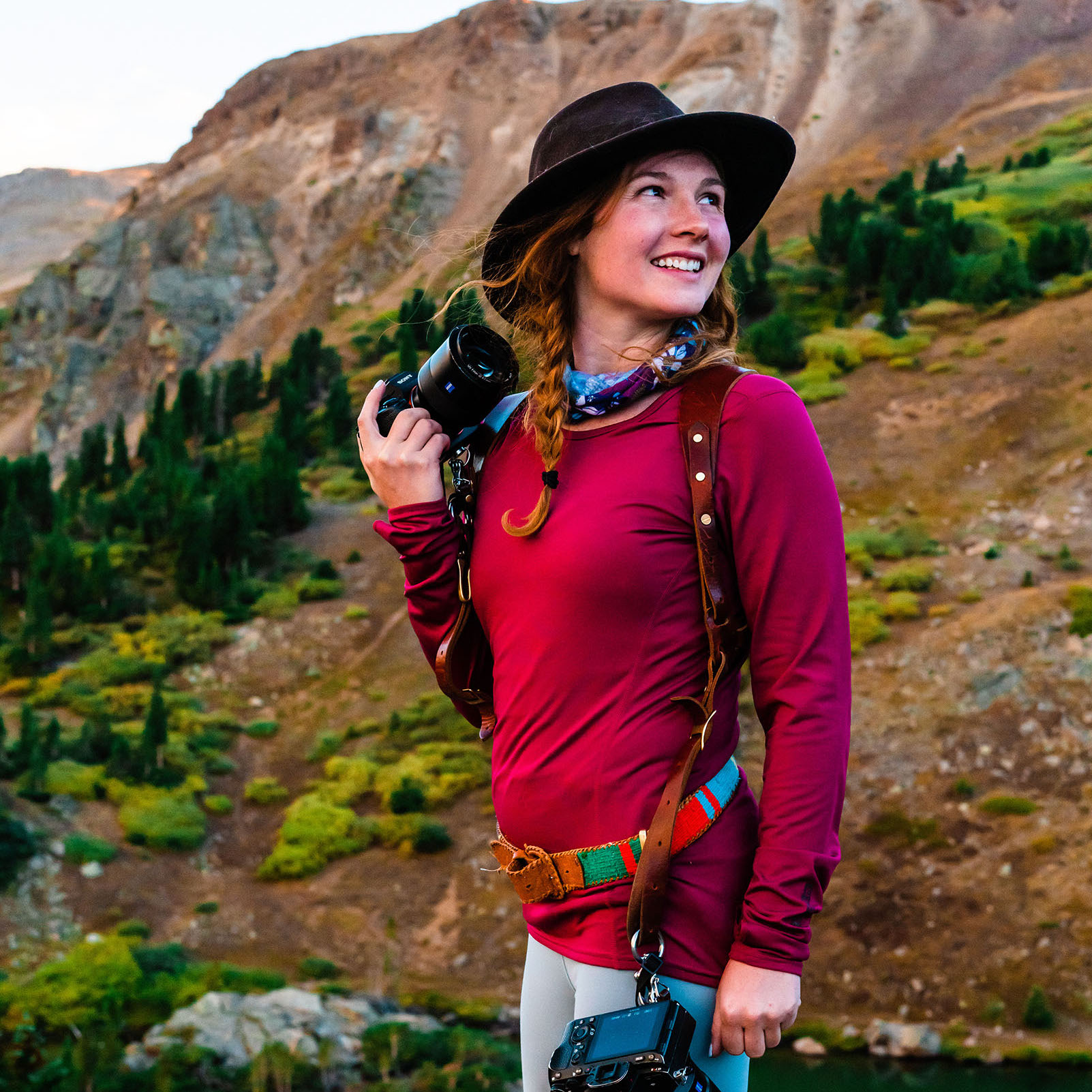 meg holding a camera in the Colorado mountains